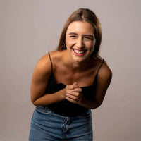 Thumbnail for Smiling woman wearing a black top, capturing joy and happiness in a candid moment.