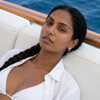 Thumbnail for Pear Crystal Huggie Hoops in Silver, worn on a yacht | SKU: 41007-silver