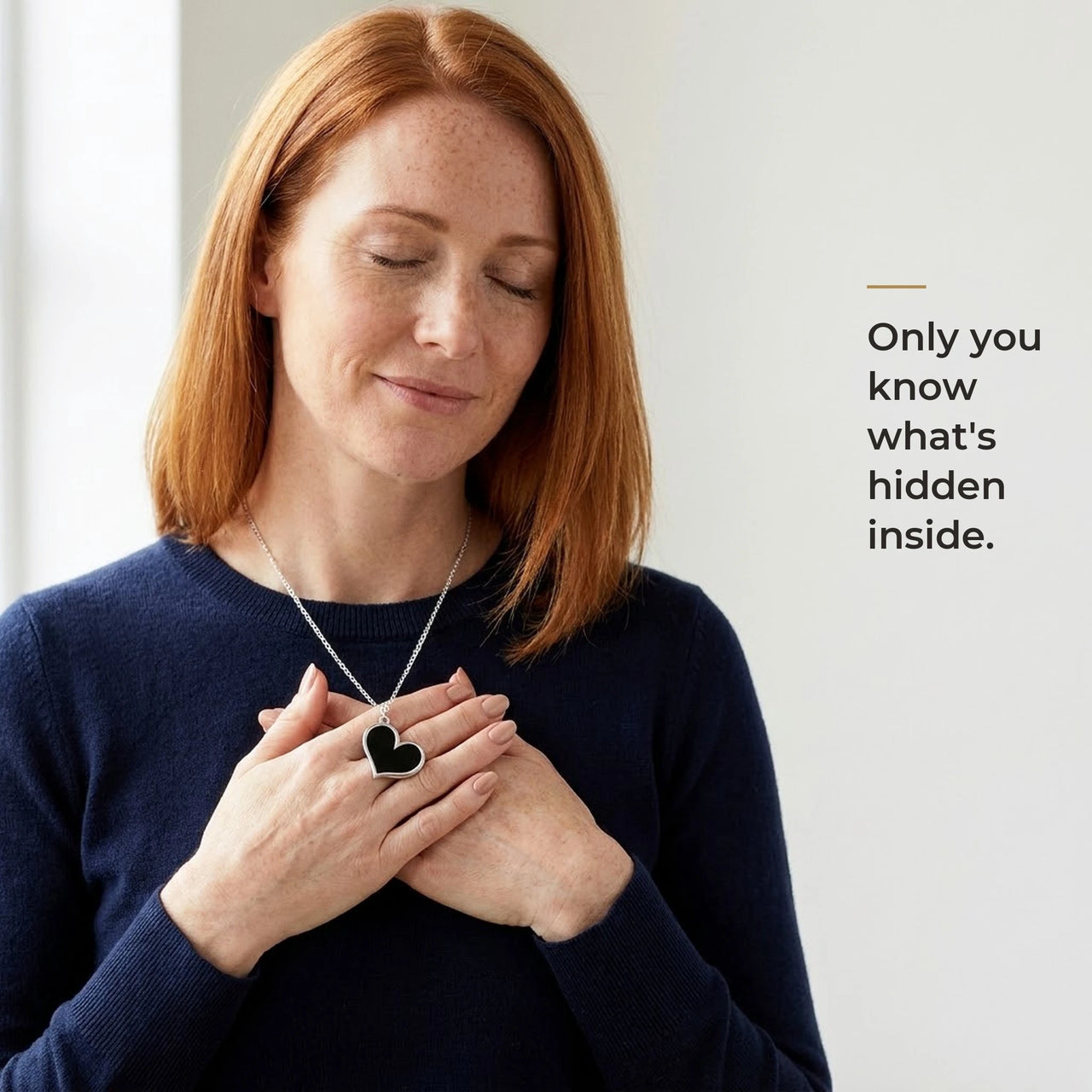 Woman holding the black silver heart pendant to her chest, only she knows the photo inside | SKU: TPH-HRTN-SILVER