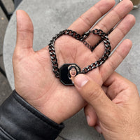 Thumbnail for Thumb warming the black octagon bracelet plate: the hidden photo appears under the thumb while the rest stays black | SKU: TPH-OCTB-BLACK-18