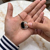 Thumbnail for Thumb warming the rose gold octagon pendant: the hidden photo appears under the thumb while the rest stays black | SKU: TPH-OCTN-ROSEGOLD