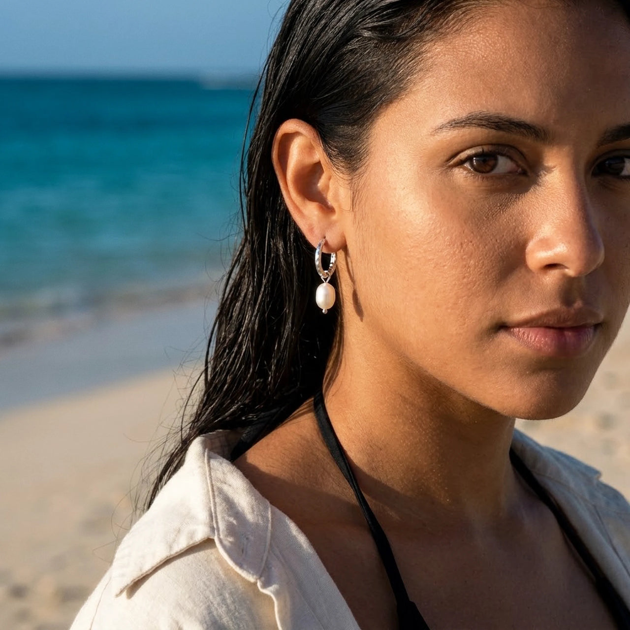 Twisted Pearl Drop Hoops in Silver, worn on the beach | SKU: 41004-silver